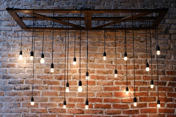 istock Old red brick wall with bulb lights lamp 985030022