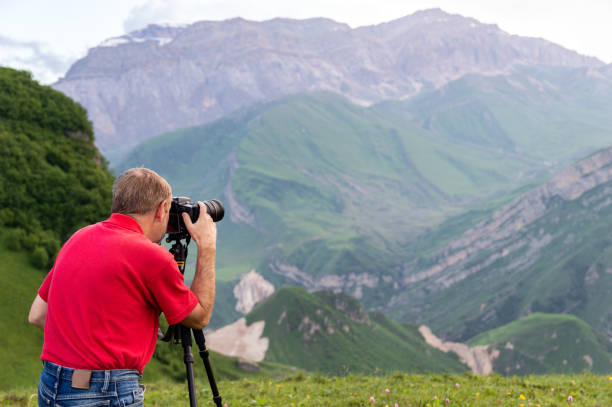 istock Nature photographer take shot in mountains 985032528