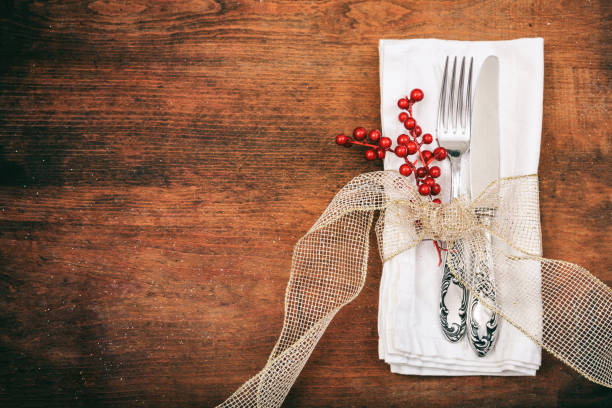 istock Place setting with fork and knife on wooden background 985032590