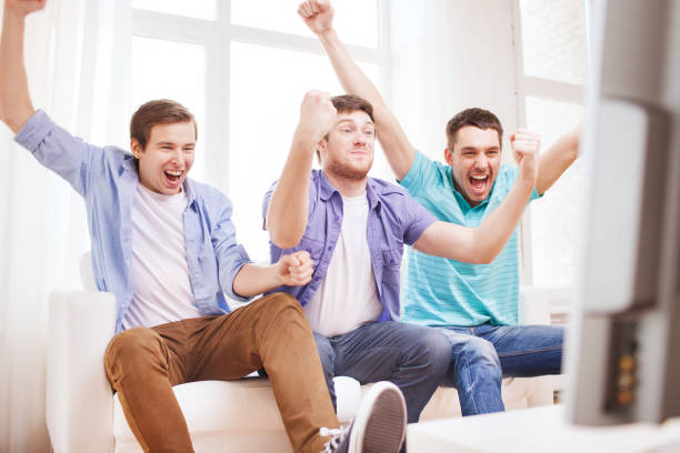 istock happy male friends at home 985032652