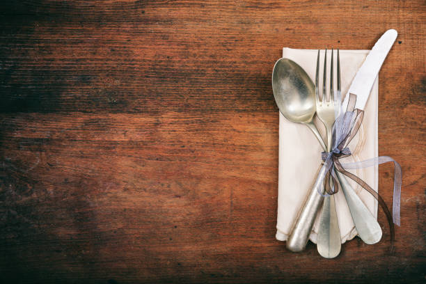 istock Table setting with fork, spoon and knife on wooden background 985032836