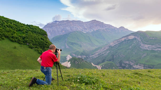 istock Nature photographer take shot in mountains 985033136