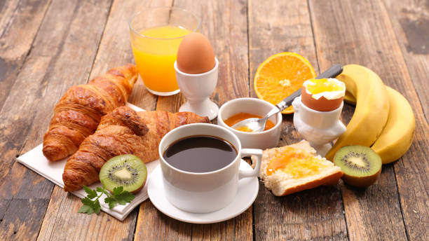 istock breakfast with coffee, egg, croissant and fruit 985033474