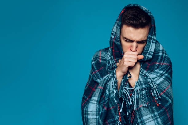 istock Young ailing guy with influenza virus coughs 985036820