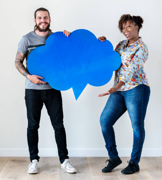 istock Happy interracial couple holding copyspace speech bubble 985037150