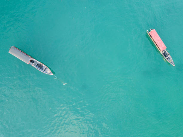 istock Two narrow boats anchored from above 985038000