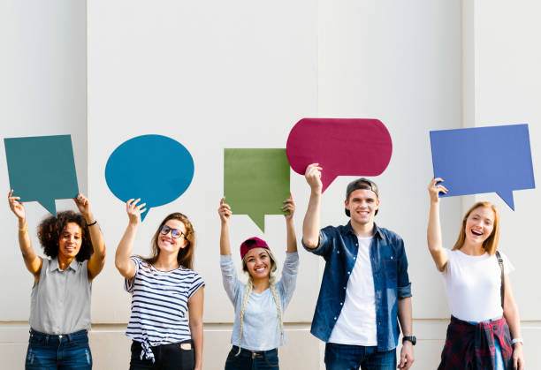 istock Young adult friends holding up copyspace placard thought bubbles 985041644