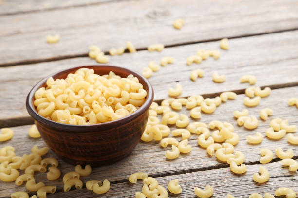 istock Pasta penne on the grey wooden table 985041802