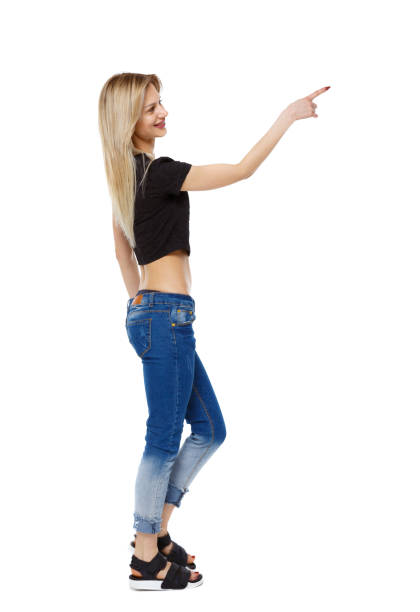 istock Side view of a girl walking with a pointing hand. 985042264