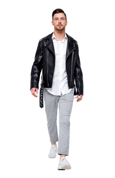 istock Front view of going  handsome man in a leather jacket and trousers. 985046150