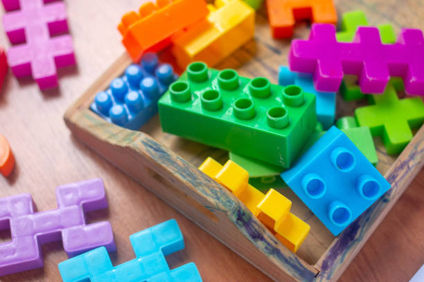 istock Toy colorful plastic blocks on wooden floor background 985047186