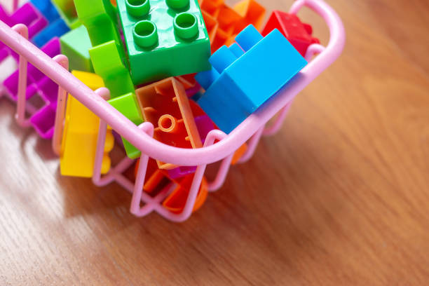 istock Toy colorful plastic blocks on wooden floor background 985047424