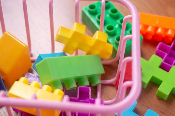 istock Toy colorful plastic blocks on wooden floor background 985047518