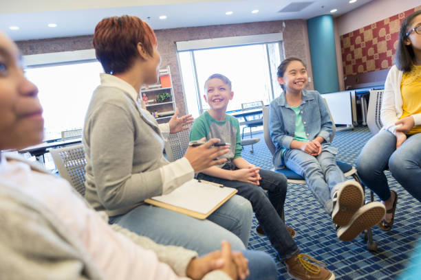 istock Teacher talks with a group of students 985047694