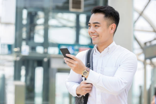istock Cheerful man uses smart phone 985048262