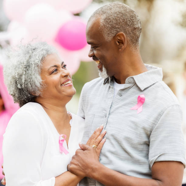 istock Confident senior couple during cancer awareness event 985048634