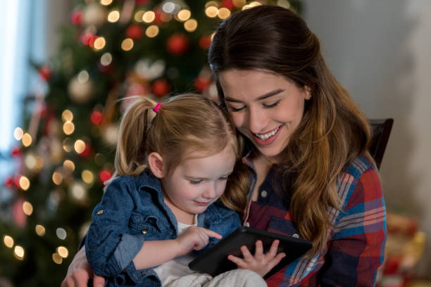 istock Mom and daughter read e-book on digital tablet 985050604