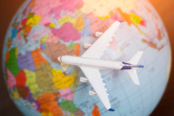 istock Airplane on the globe. Travel concept. Close up 985051140