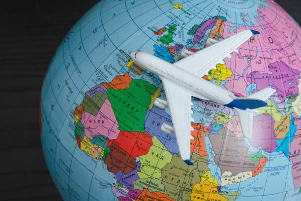 istock Airplane on the globe. Travel concept. Close up 985051158