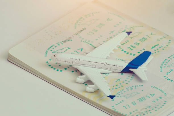 istock Airplane on passport pages with a visa. Close up 985051172