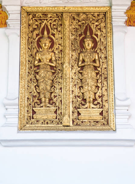 istock Golden angel carving on the old window. 985056958
