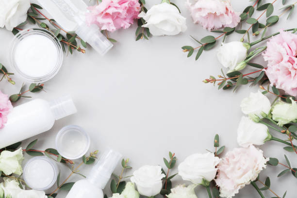 istock Frame from natural cosmetic and flowers on pastel table top view. 985057782
