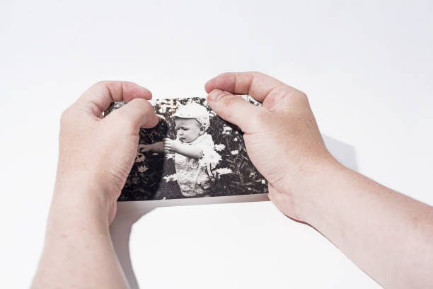 istock Old paper photo in mans hands. 985058436