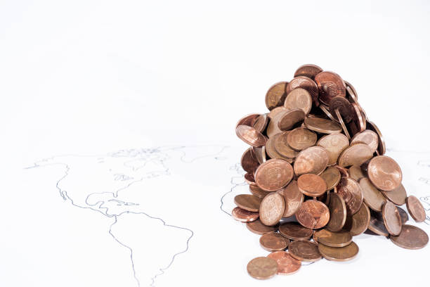 istock A lot of coins on World Map. 985058452