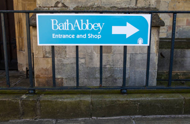 Bath Abbey Sign BATH, UK - MARCH 28TH 2016: A direction sign to the Bath Abbey main entrance and shop in Bath, on 28th March 2016. bath abbey stock pictures, royalty-free photos & images