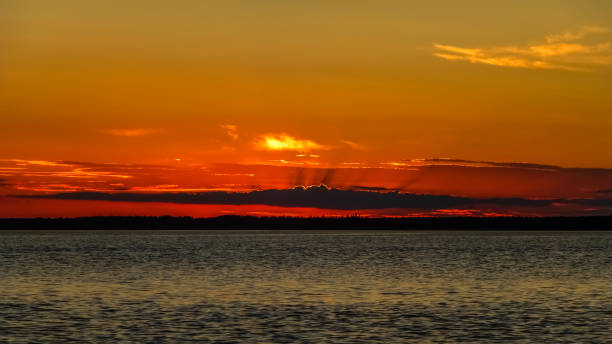 istock Red sky in the sunset behind clouds 985059260