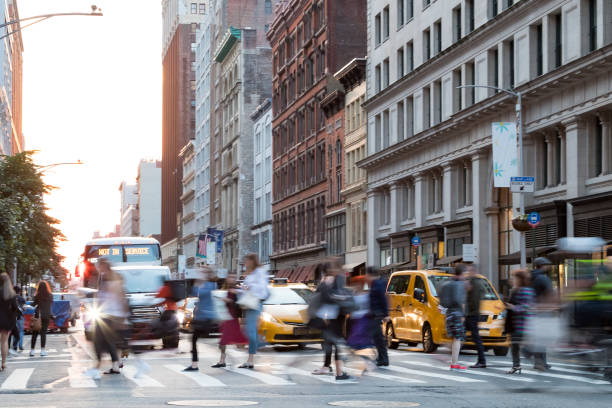 Busy people in motion across an intersection on Broadway in Manhattan New York City Busy people in motion across an intersection on Broadway in Manhattan New York City soho new york stock pictures, royalty-free photos & images