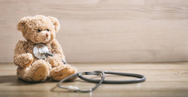 istock Teddy bear with a heart stethoscope 985069638