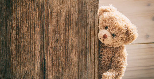 Teddy bear on wooden background Teddy bear on wooden background, copy space behavior teddy bear doll old stock pictures, royalty-free photos & images