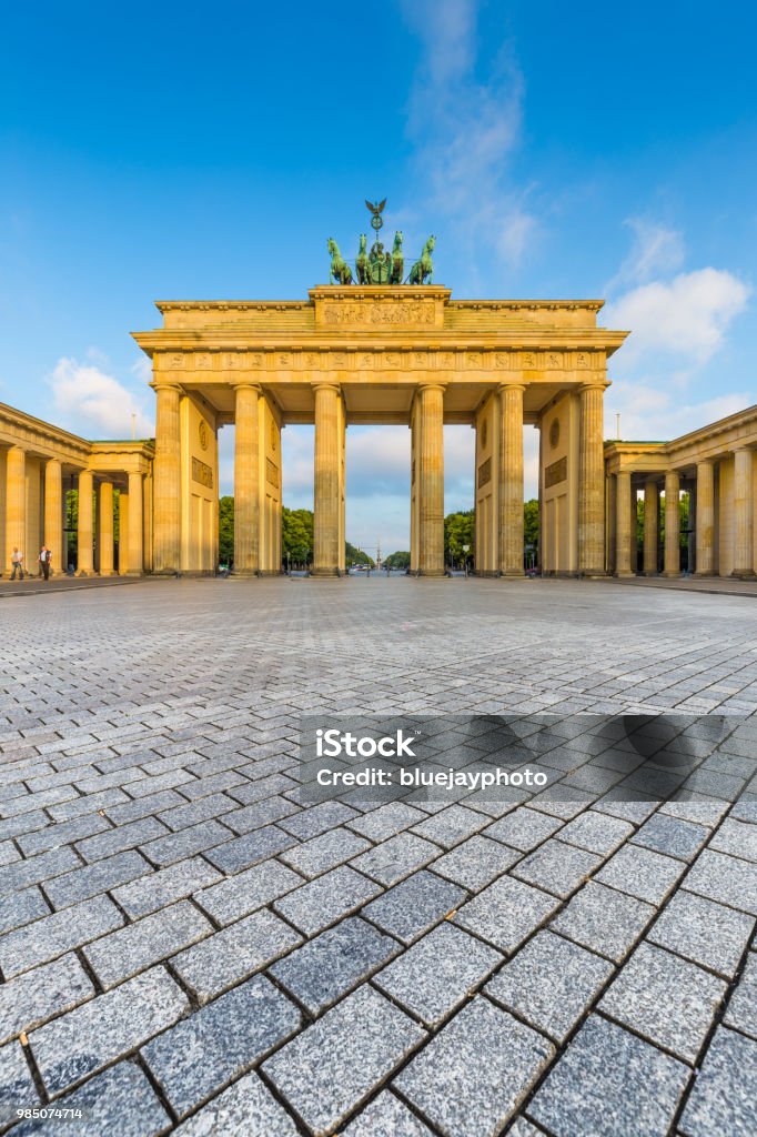 Brandenburg Gate at sunrise, Berlin, Germany Classic view of famous Brandenburg Gate, one of the best-known landmarks and national symbols of Germany, in beautiful golden morning light at sunrise in summer, central Berlin, Germany Berlin Stock Photo