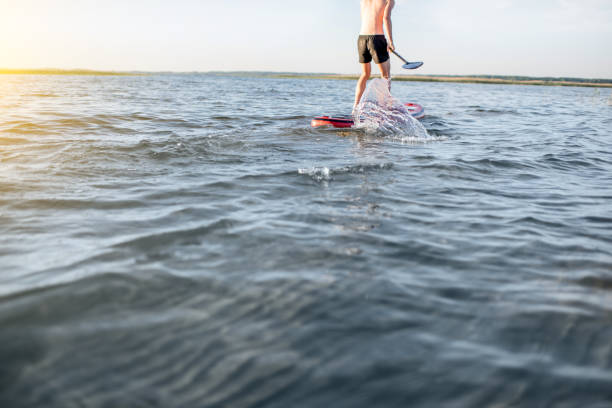 istock Man paddleboarding on the lake 985083008