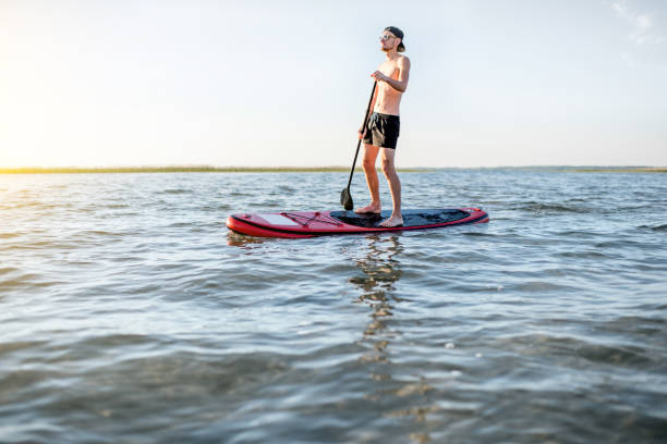 istock Man paddleboarding on the lake 985083070