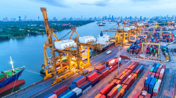 istock Container ship in export and import business and logistics. Shipping cargo to harbor by crane. Water transport International. Aerial view and top view. 985083104