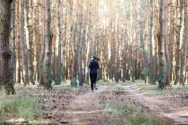 istock Woman running in the forest 985086862