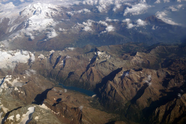 istock Top view of high mountains and clouds 985087238