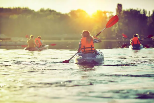 Kayaking and canoeing with family. Children on canoe. Family on kayak ride.