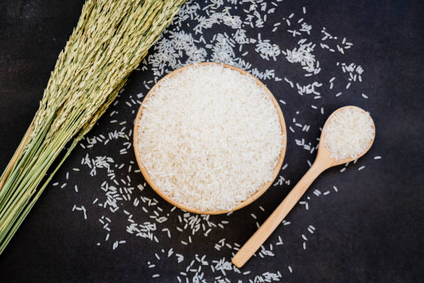istock Close-Up Of Rice Grains In Bowl By Crops On Table 985092164