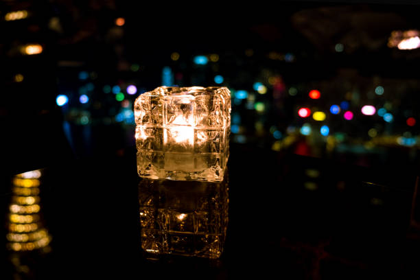 istock Burning candle in glass cup with abstract background 985092180