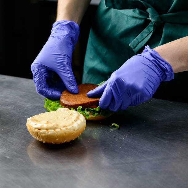 istock Unidentified chef preparing veggie burger with yummy vegetable p 985103758