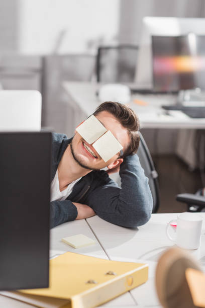 istock happy man with stickers on eyes at office 985104298