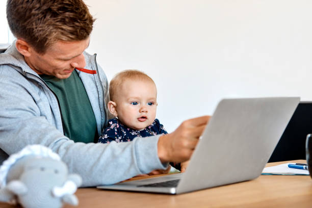 istock Father pointing on laptop screen to baby boy 985108246