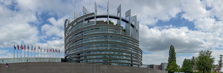 STRASBOURG, FRANCE - JUNE 18, 2018: All EU Flags European Union flag waving in front of European Parliament, headquarter of the European Commission European Parliament