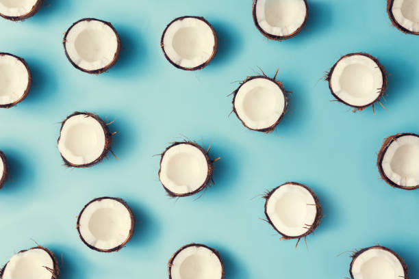 istock Coconut fruit colorful pattern on a pastel blue background. Summer concept. Flat lay. 985110972