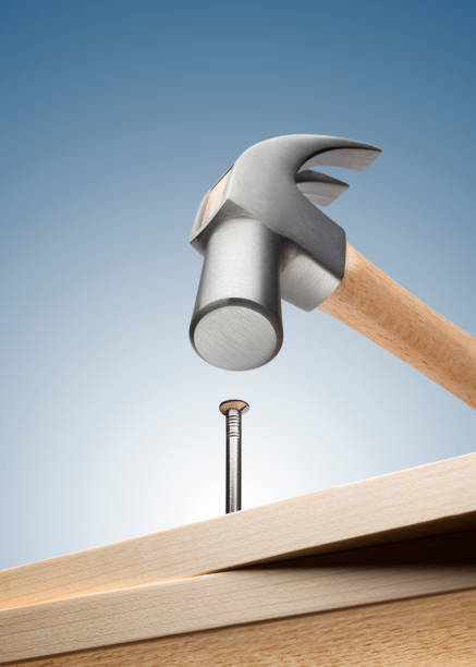Hammer hitting nail on white background Hammer hitting nail on the head on white background. hit the nail on the head stock pictures, royalty-free photos & images