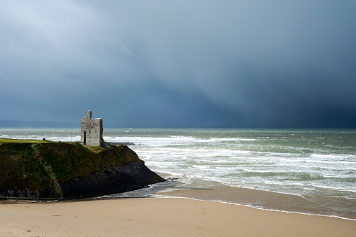 winter rain storm approaching ballybunion beach and castle