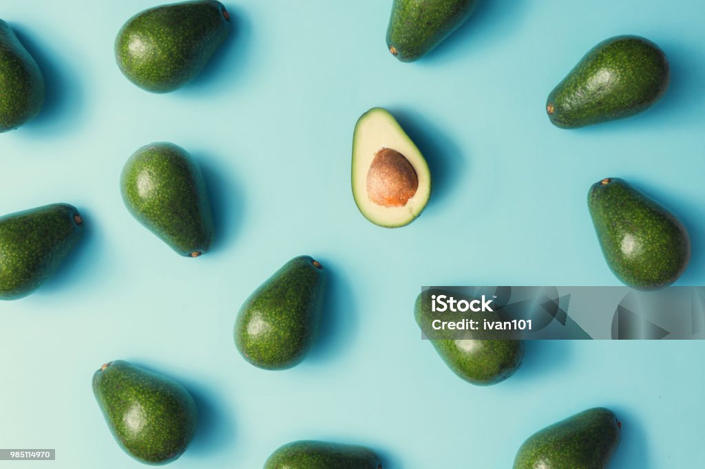 Avocado colorful pattern on a pastel blue background. Summer concept. Flat lay. Avocado Stock Photo